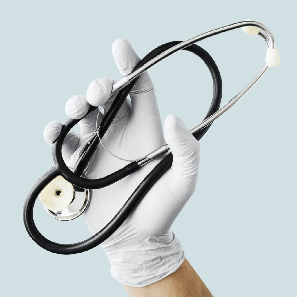 Hand with latex glove holding a stethoscope duting a virus outbreak mockup